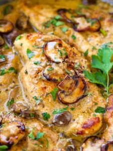 A close up of creamy chicken Marsala with mushrooms and parsley