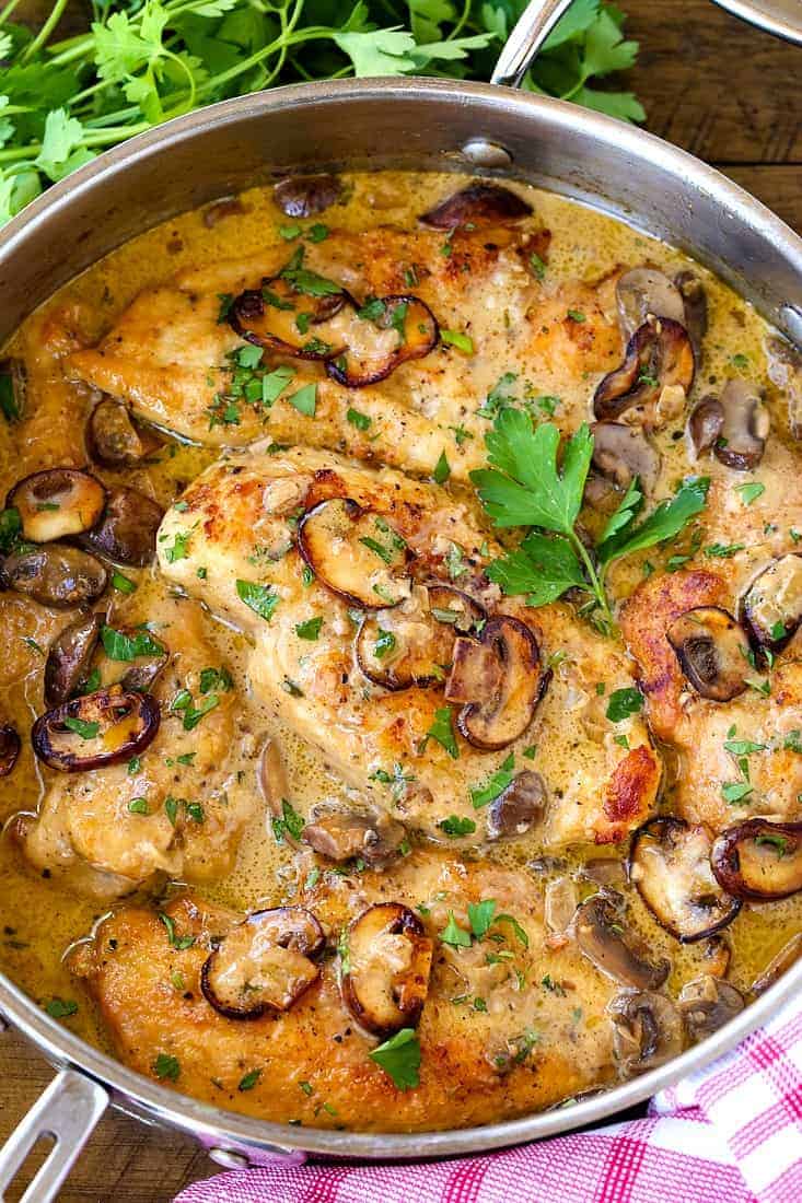 A big pan filled with chicken, mushrooms and marsala sauce