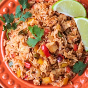 chicken fajita rice on plate with limes and cilantro