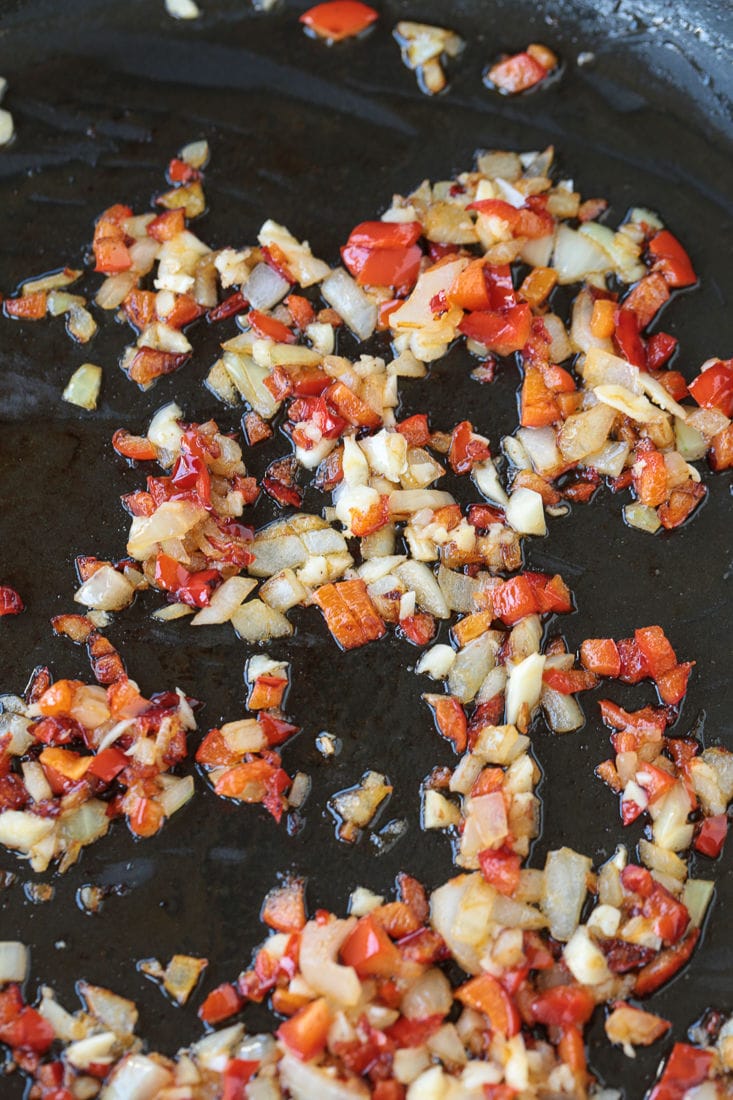 diced peppers and onions in a skillet