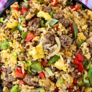 fried rice with ground beef, peppers and cheese in a bowl