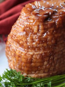 glazed spiral ham on platter with parsley