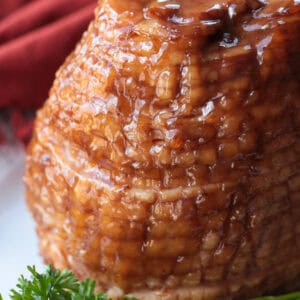 glazed spiral ham on platter with parsley