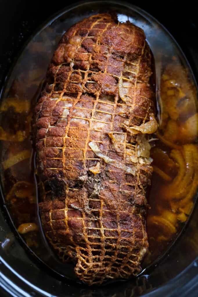 pork butt in slow cooker with juice