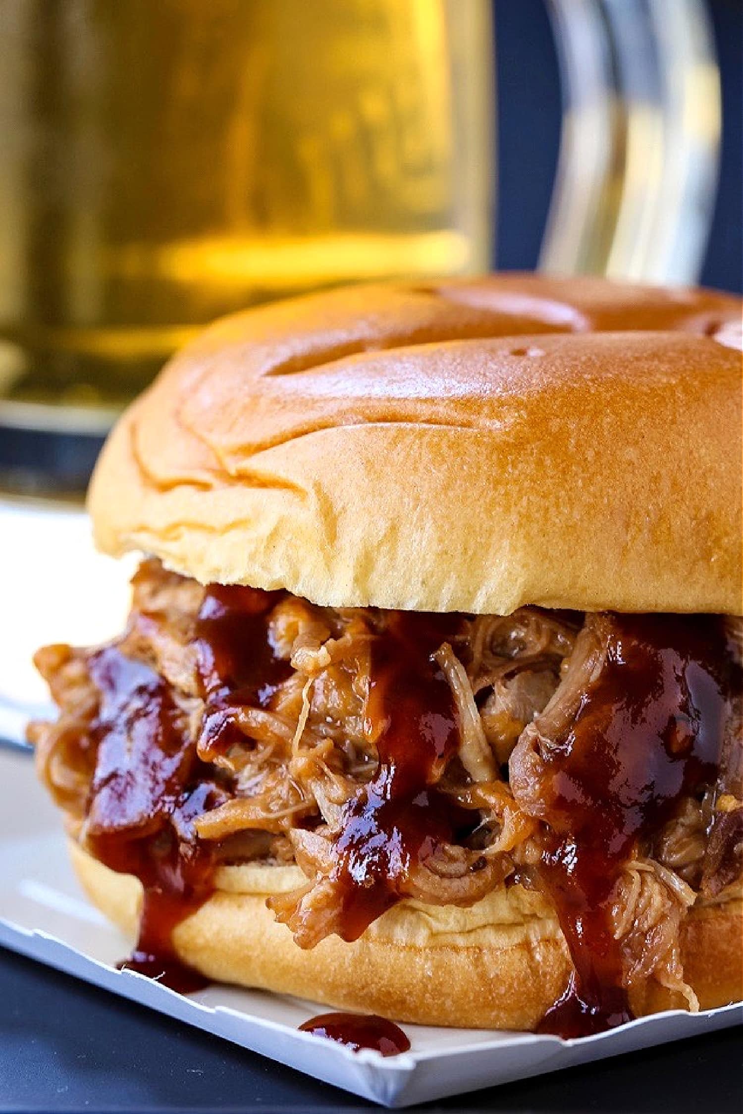 pulled pork sandwich with beer behind