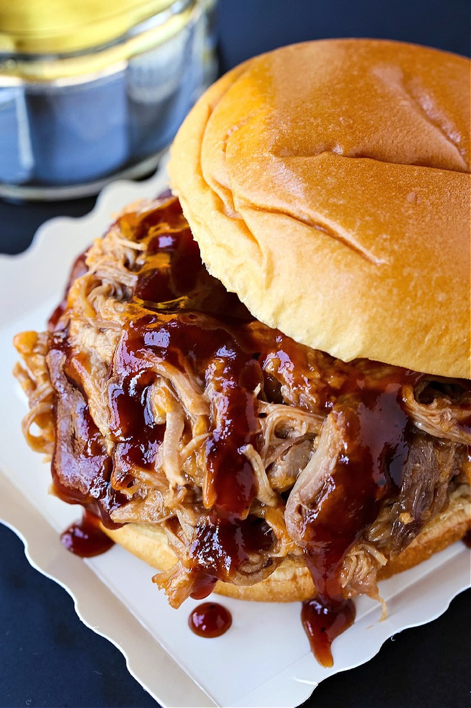 bbq pulled pork sandwich with sauce dripping down