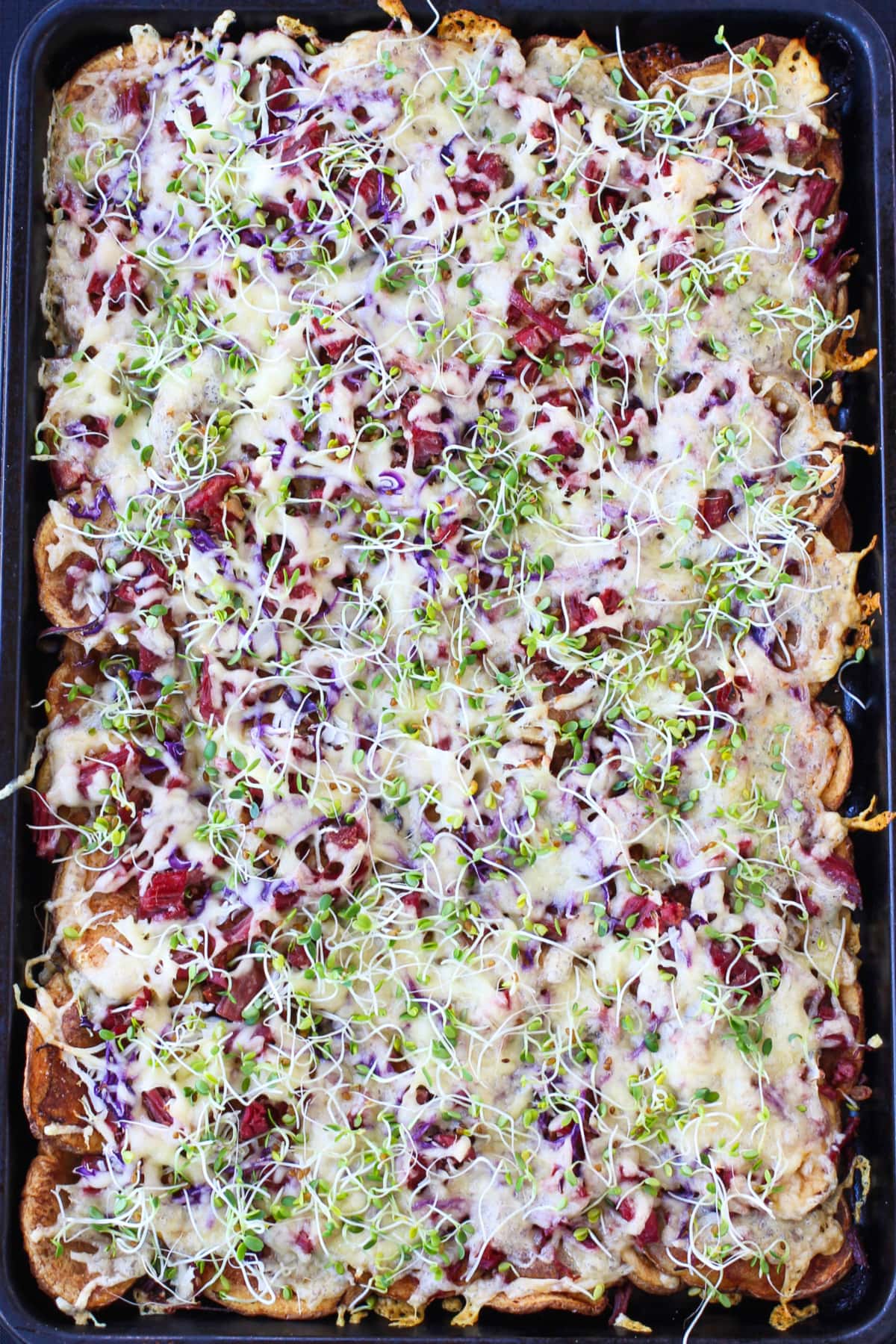 Irish Nachos with Corned Beef are perfect for St. Patrick's Day! Thin, crispy potatoes topped with corned beef and tons of cheddar cheese. baked Irish nachos with cabbage, corned beef and cheese