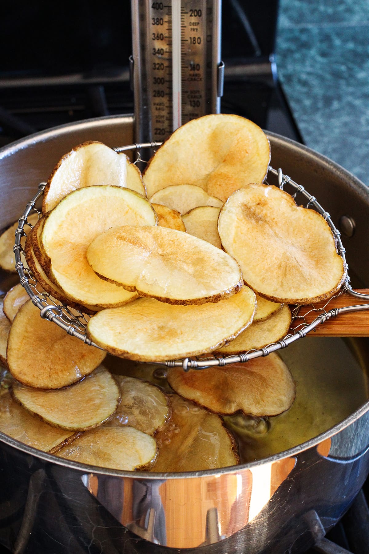 fried potato chips coming out of oil