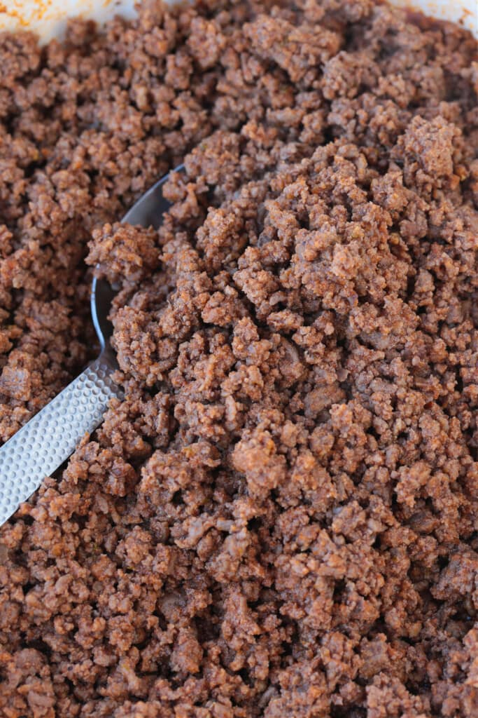 ground beef taco meat in skillet with serving spoon