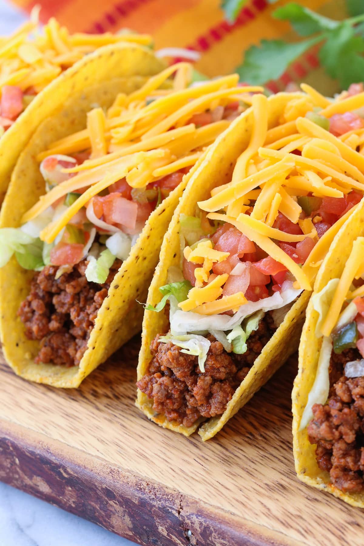 Make taco night even better with our homemade Ground Beef Taco Meat! 15 minutes is all you need to have the most delicious, homemade tacos! ground beef tacos with toppings on a board