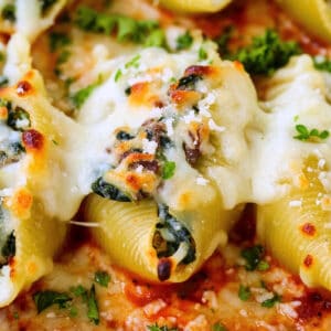 cheesy stuffed shells in baking dish with sauce