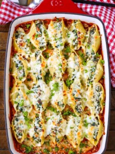 A Baking dish packed with creamy Beef Stuffed Shells in tomato sauce.
