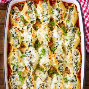 A Baking dish packed with creamy Beef Stuffed Shells in tomato sauce.