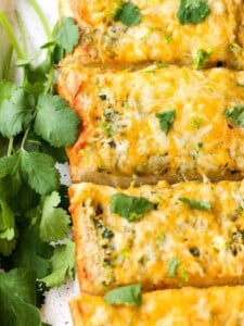 Cheesy Mexican Garlic Bread is a garlic bread recipe with a Mexican blend cheese melted on top