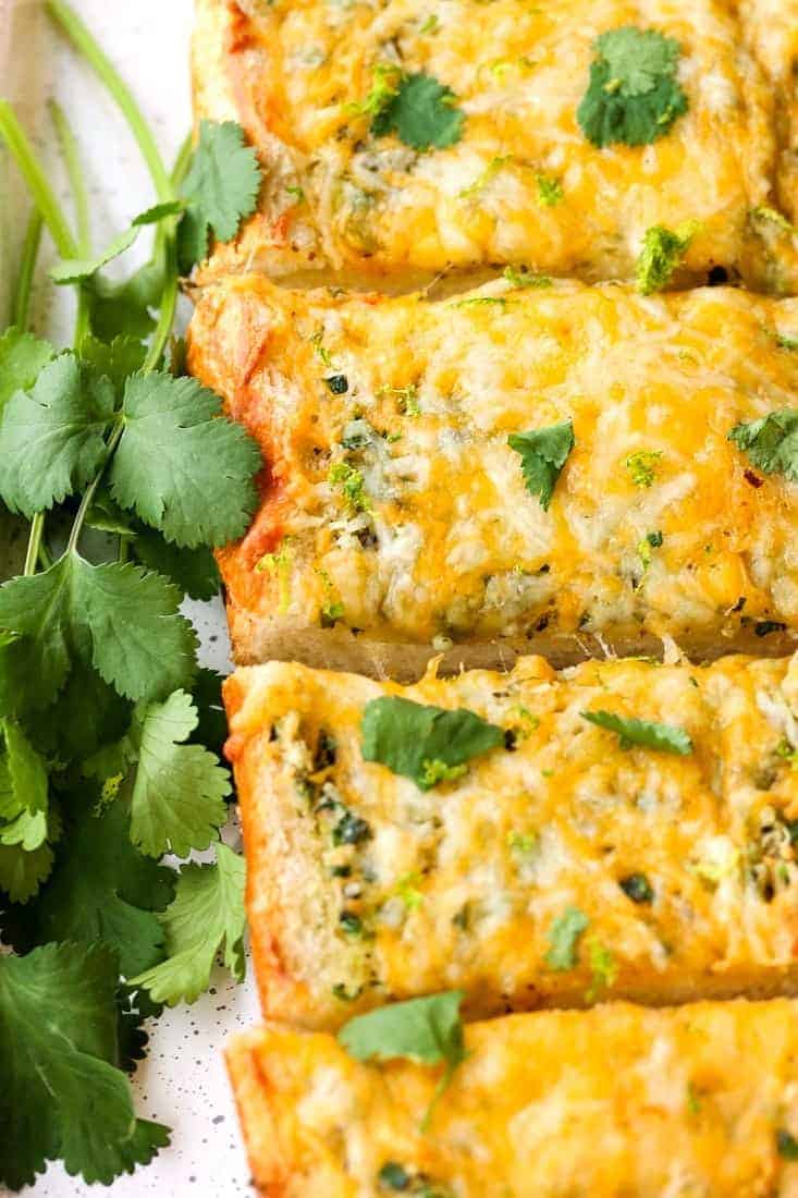 Cheesy Mexican Garlic Bread is a garlic bread recipe with a Mexican blend cheese melted on top