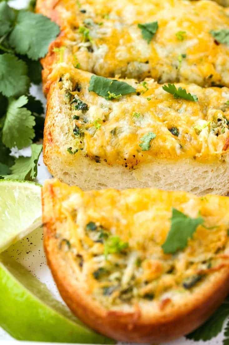 This Cheesy Mexican Garlic Bread is a fun side dish for everyday dinners, but also a super tasty appetizer for your next holiday or party! Cheesy Mexican Garlic Bread is an appetizer or side dish recipe