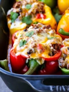 Cheesy Mexican Stuffed Peppers are topped with cheese and filled with beef and beans