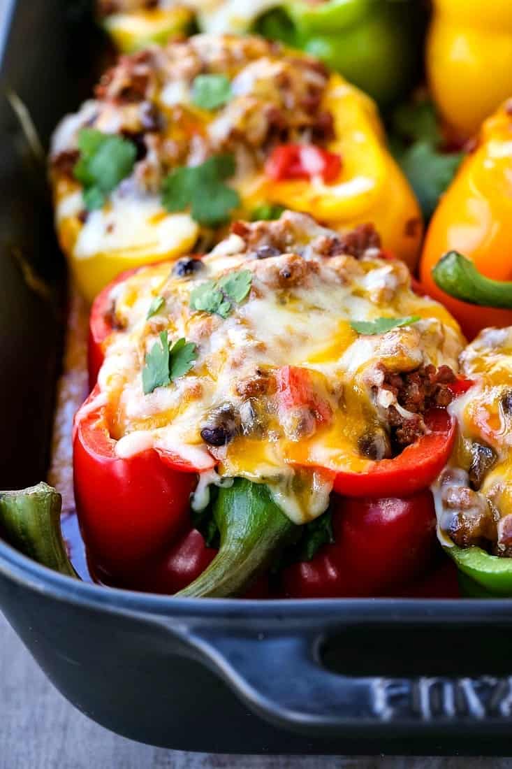 Cheesy Mexican Stuffed Peppers are topped with cheese and filled with beef and beans