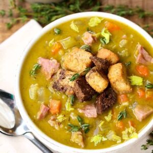 split pea soup in a white bowl with croutons
