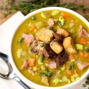 split pea soup in a white bowl with croutons