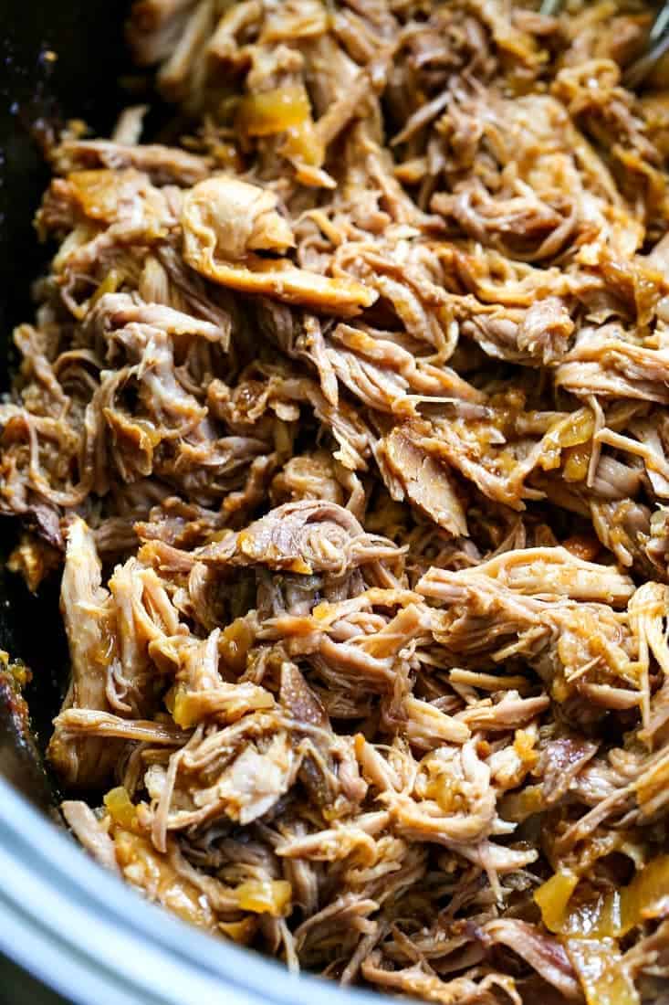 Slow Cooker Pulled Pork is shredded and mixed with the cooking liquid and onions