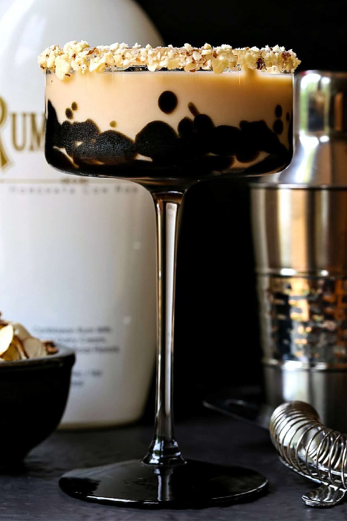 This creamy Toasted Almond Cocktail tastes just like the iconic ice cream bar! A fun dessert cocktail for parties, date nights or happy hour! toasted almond cocktail with bottle and shaker