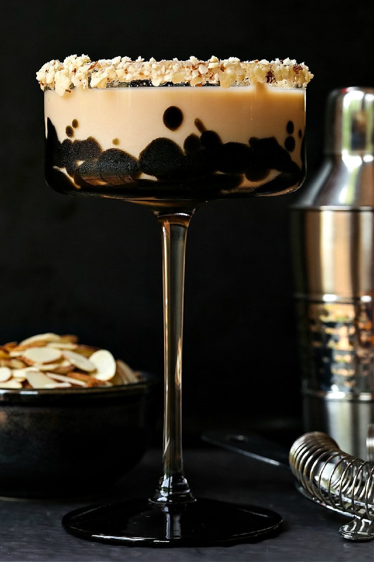 This creamy Toasted Almond Cocktail tastes just like the iconic ice cream bar! A fun dessert cocktail for parties, date nights or happy hour! toasted almond cocktail with black background