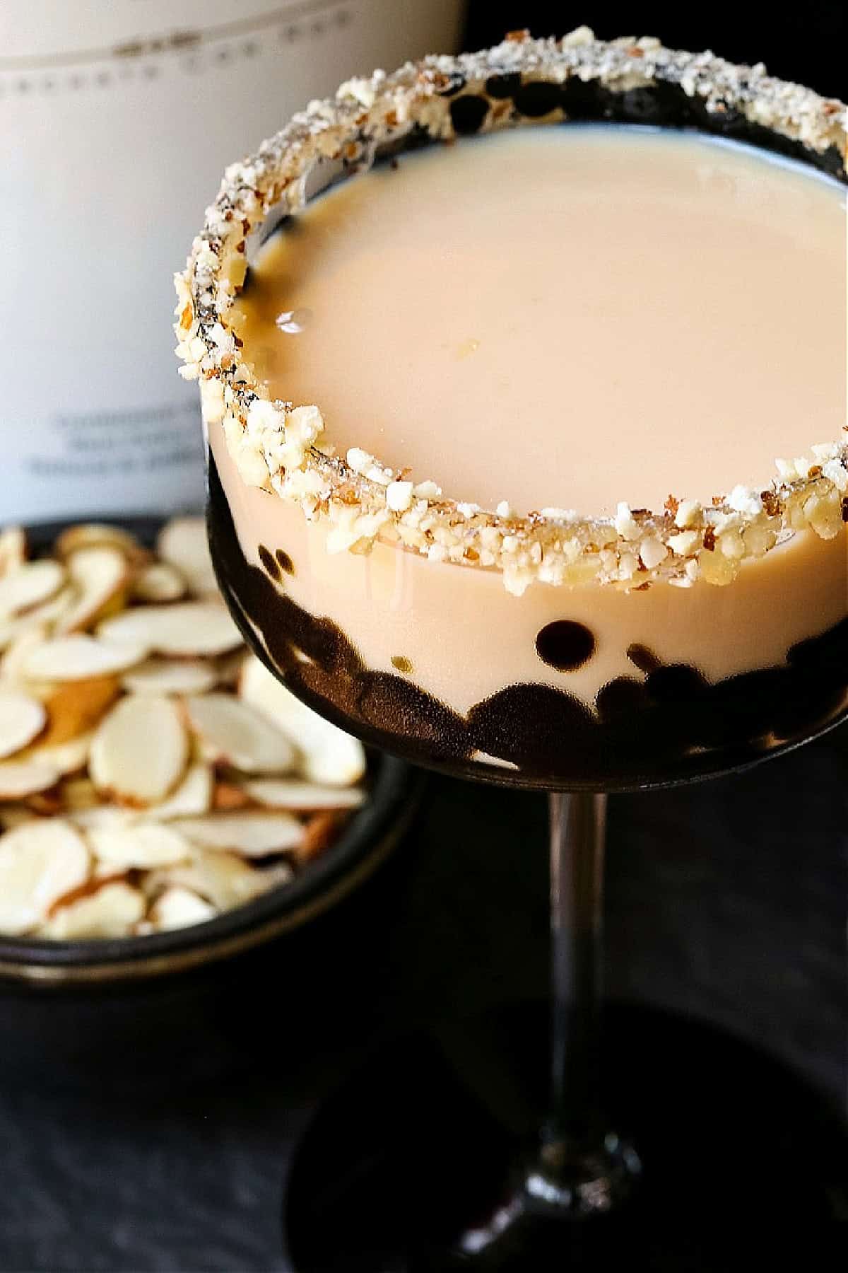 This creamy Toasted Almond Cocktail tastes just like the iconic ice cream bar! A fun dessert cocktail for parties, date nights or happy hour! creamy almond cocktail with crunchy almond rim
