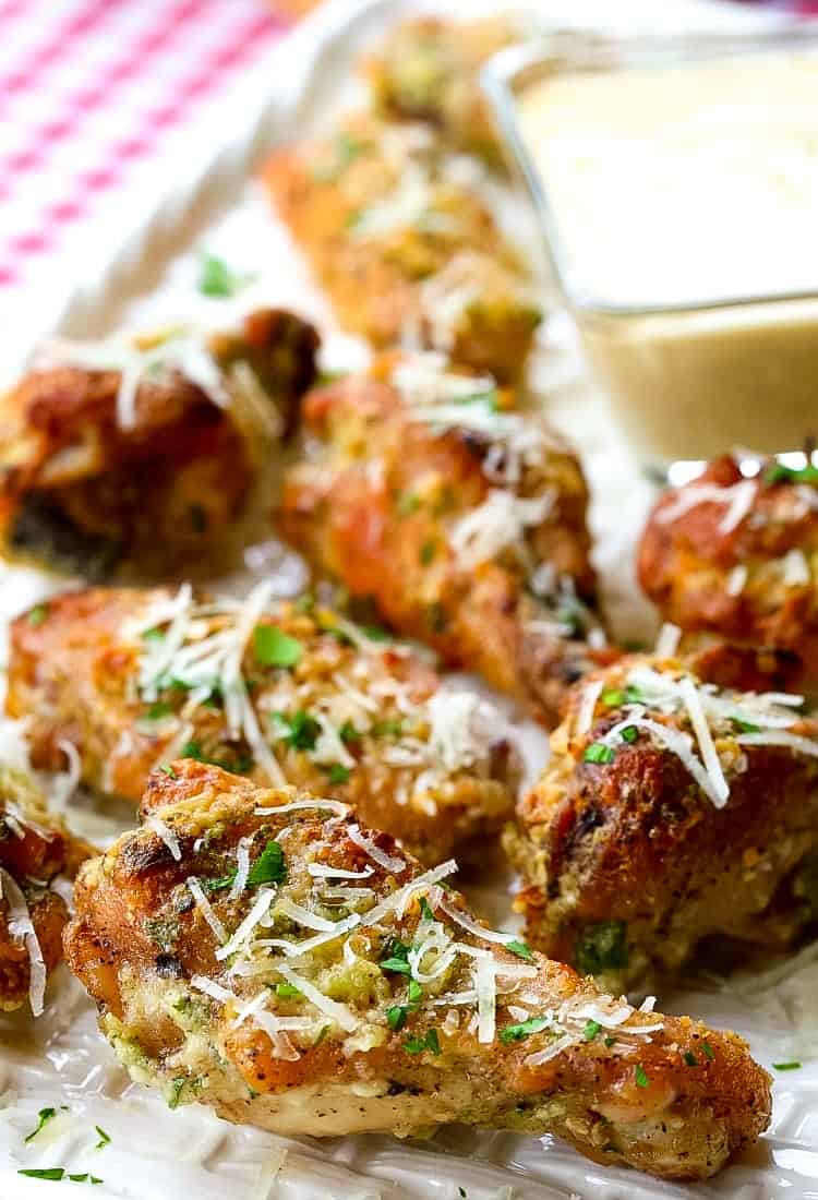 Golden-brown chicken wings with parsley and grated parmesan.