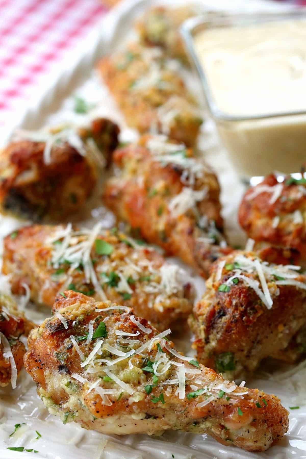 chicken wings with shredded parmesan cheese on top