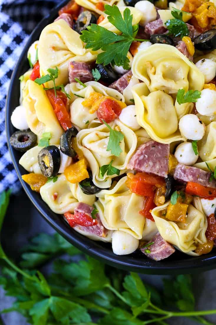 Italian Pasta Salad in a bowl with parsley and a checkered napkin