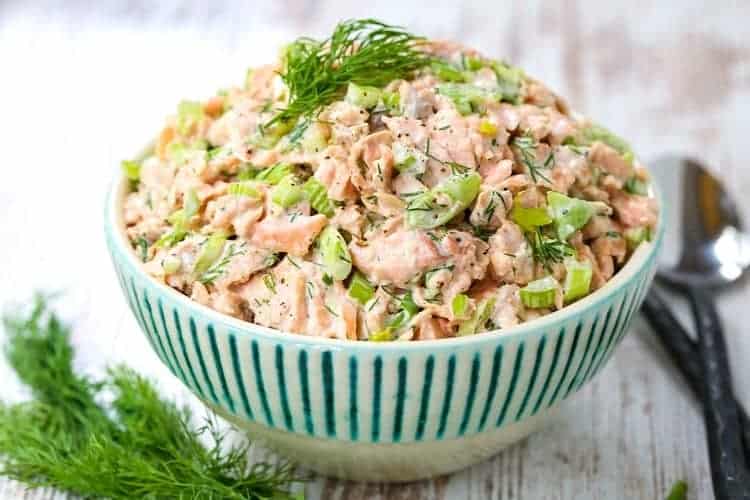 Salmon Salad recipe in a bowl with spoons and fresh dill