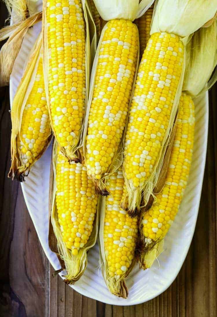 Oven Roasted Corn on the Cob shows roasted corn peeled on a platter