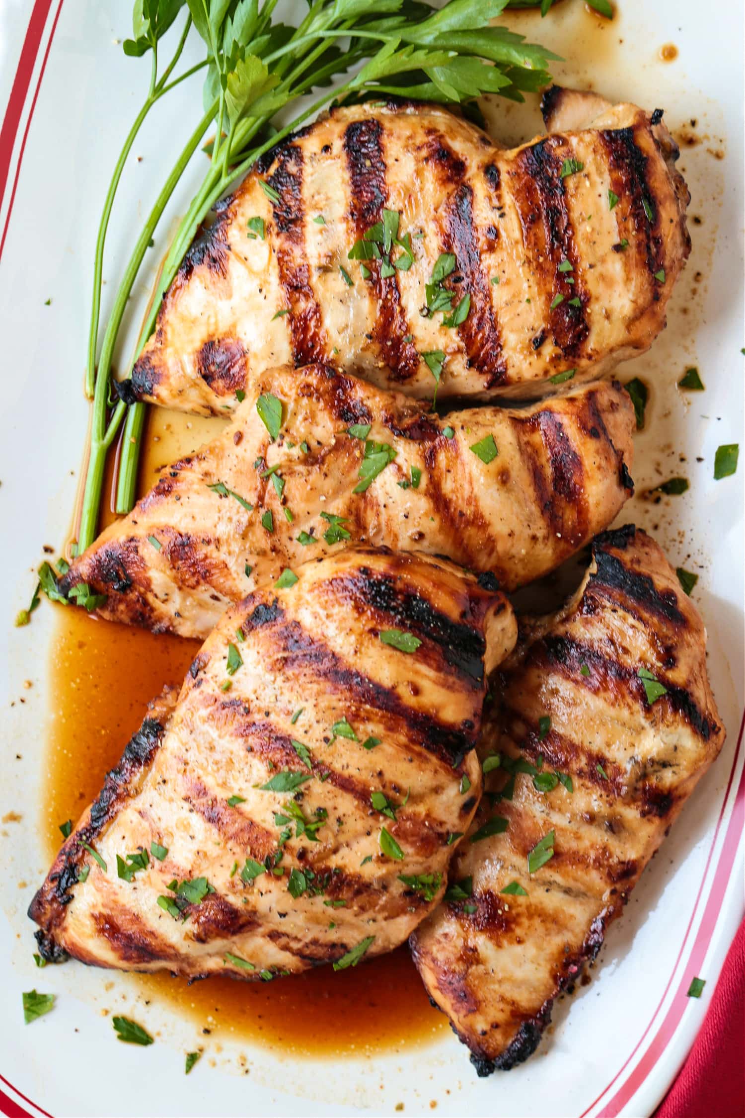 marinated, grilled chicken breasts on a platter