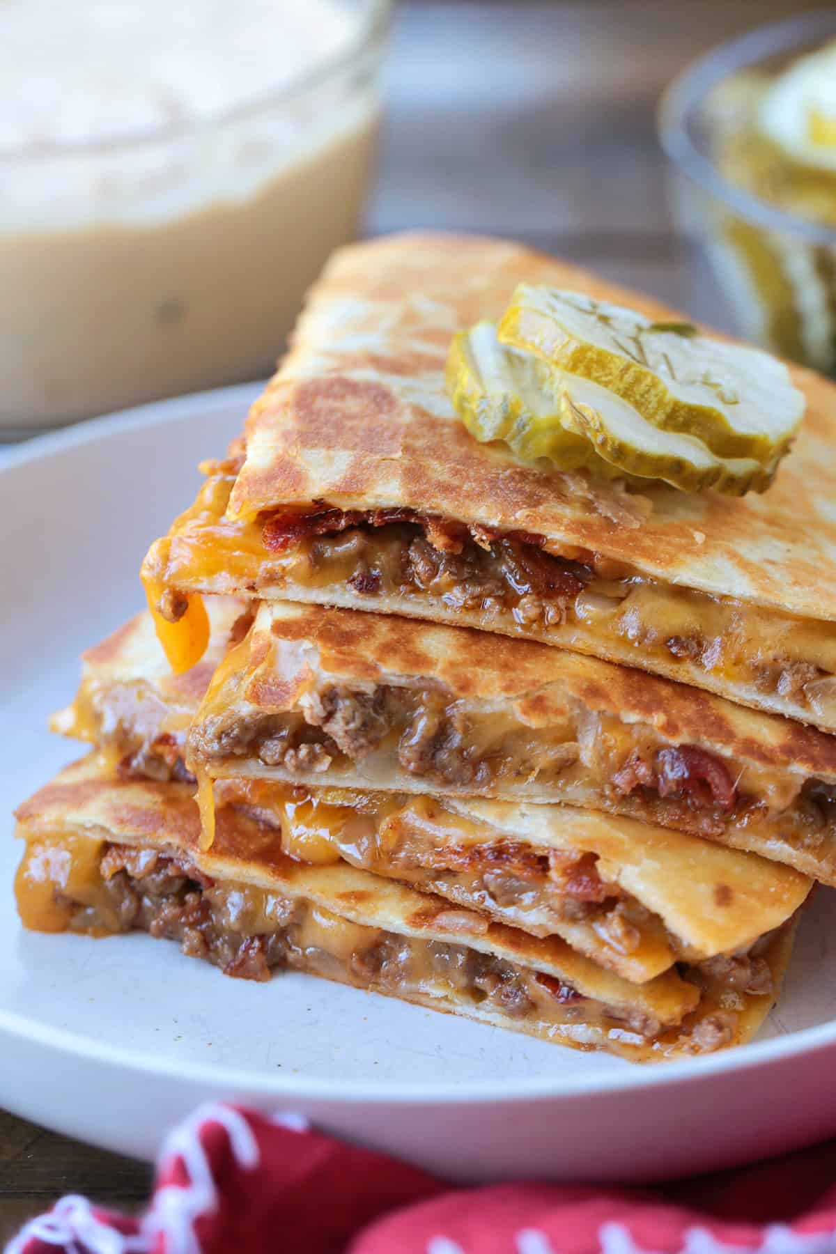 cheeseburger quesadillas with pickles and sauce on the side