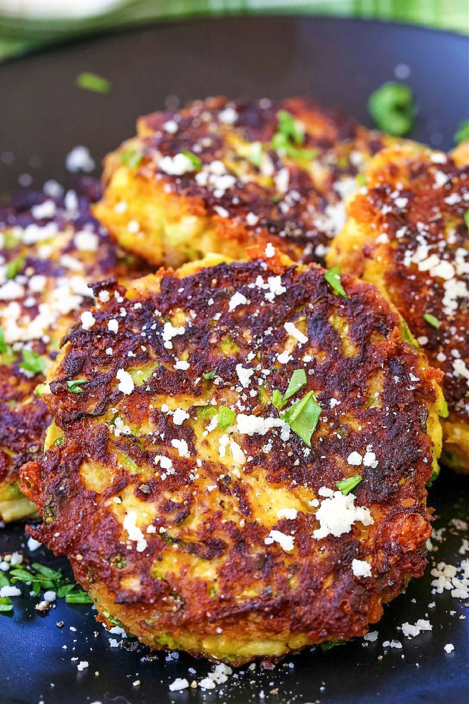 zucchini cakes placed on black plate