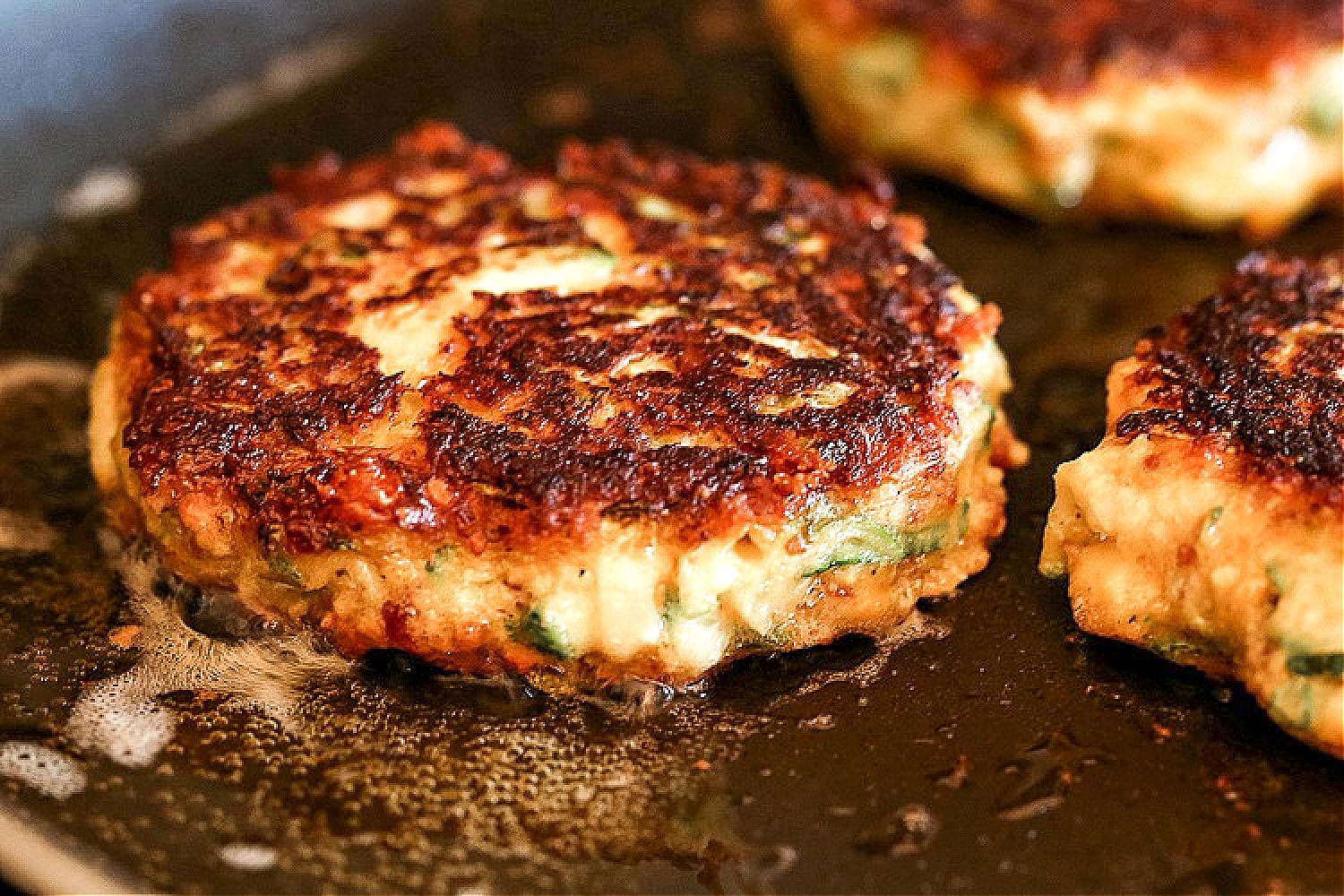 crispy zucchini cakes in skillet