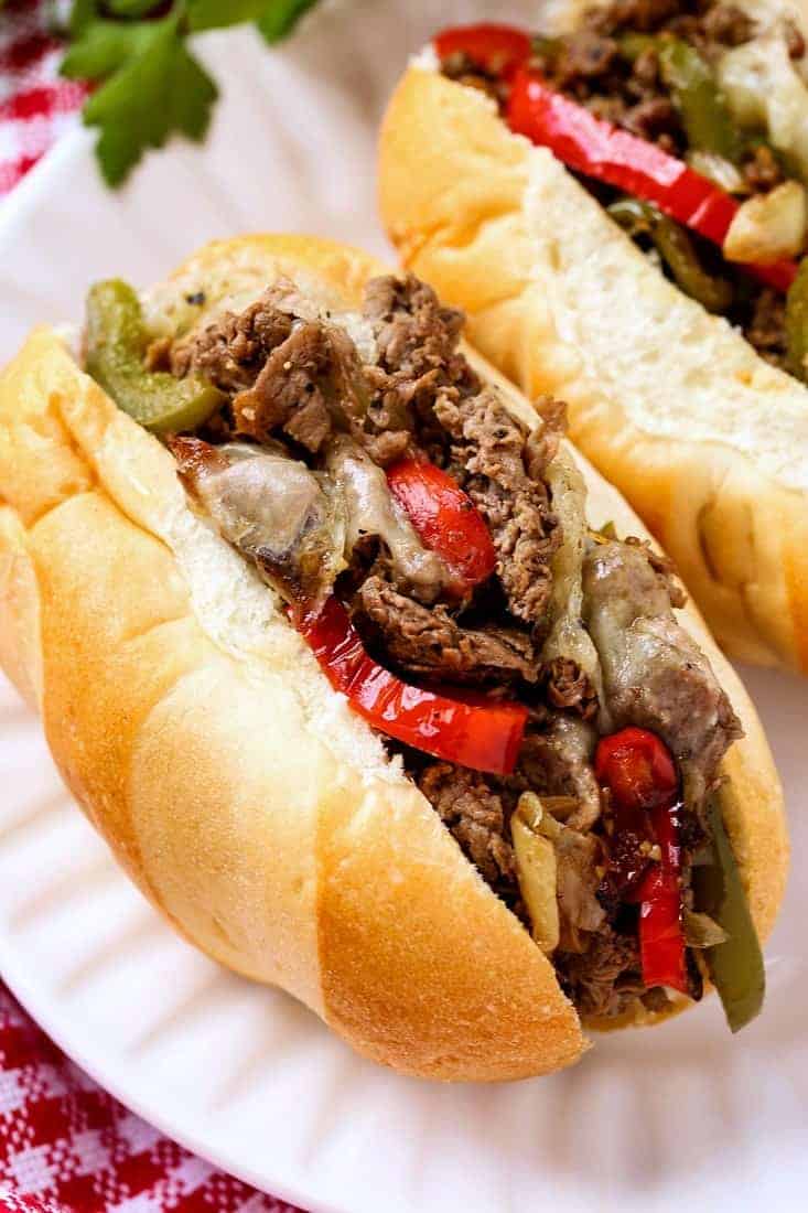 Quick Philly Cheesesteak Recipe in a sub roll on a white plate