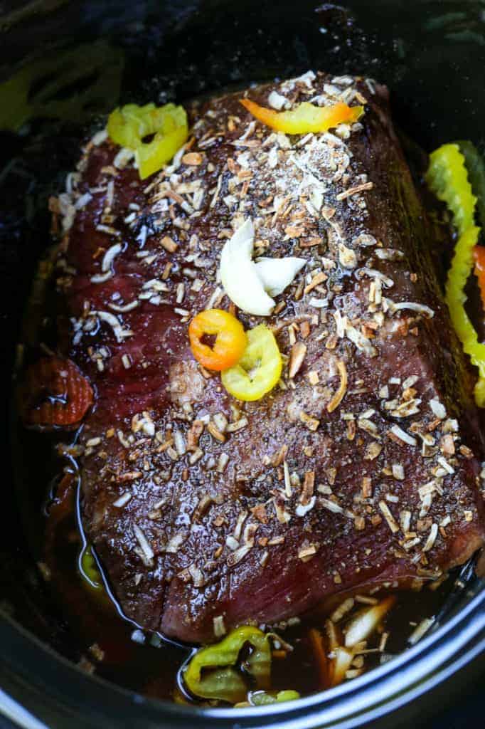 This Italian Beef Pizza has all the flavors of an Italian Beef Sandwich baked on a pizza! A fun recipe to serve at game days and parties! rump roast in a crock pot before cooking