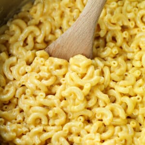 pot with wooden spoon in macaroni and cheese