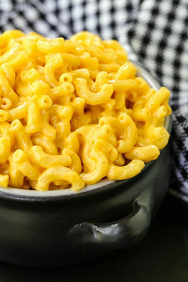 Easy Stove Top Mac and Cheese is a black bowl with a black and white napkin