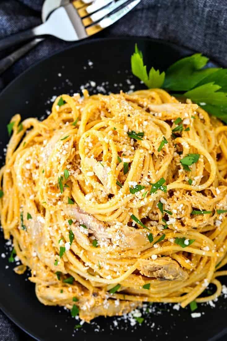 buffalo chicken spaghetti on a black plate