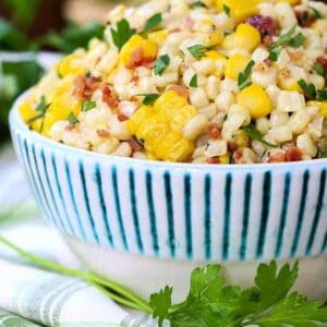 creamed corn in a bowl with parsley