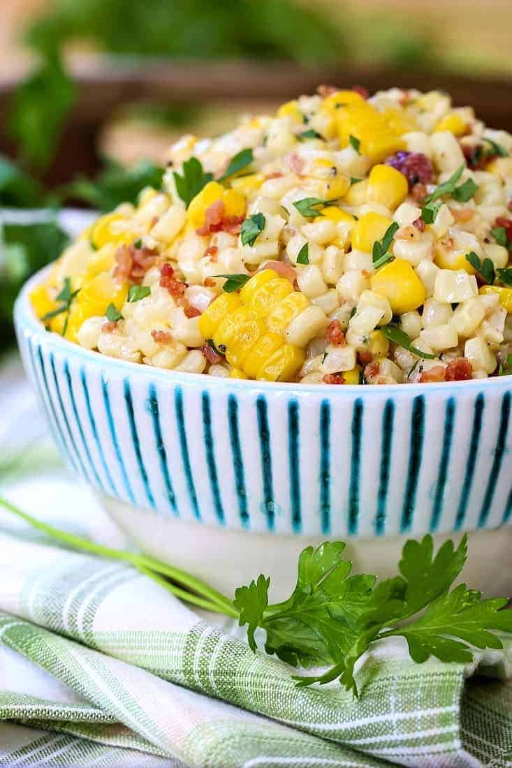 creamed corn in a bowl with parsley