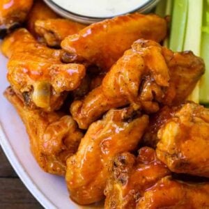 buffalo chicken wings stacked on a platter