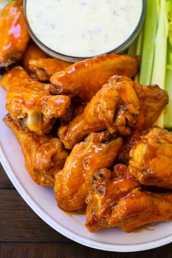 buffalo chicken wings stacked on a platter