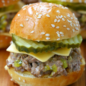 sloppy joe with cheese and pickles on board