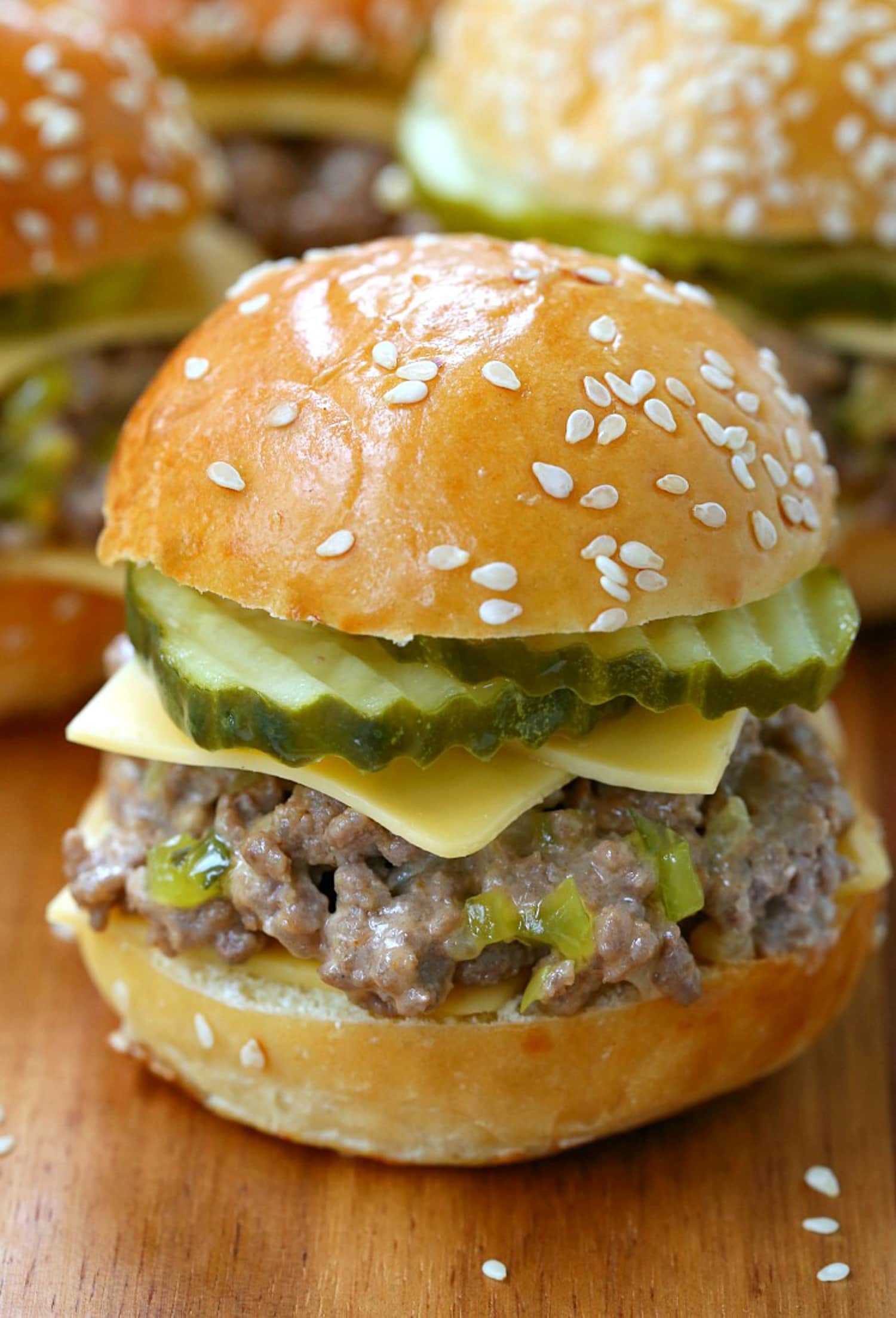 sloppy joe with cheese and pickles on board