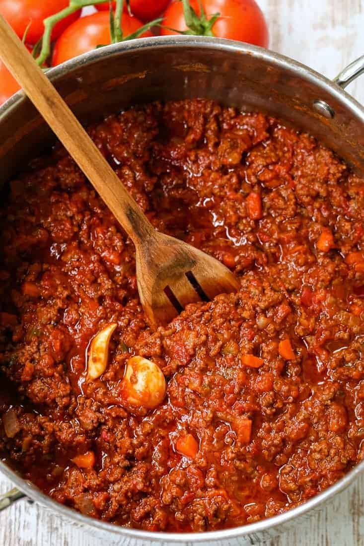 bolognese sauce in a pot with a wooden spoon