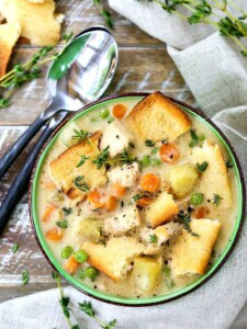 chicken pot pie soup with spoons on a wooden board